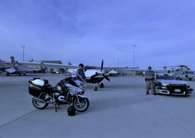Photo of Colorado State Patrol Vehicles including a motorcycle and a plane.